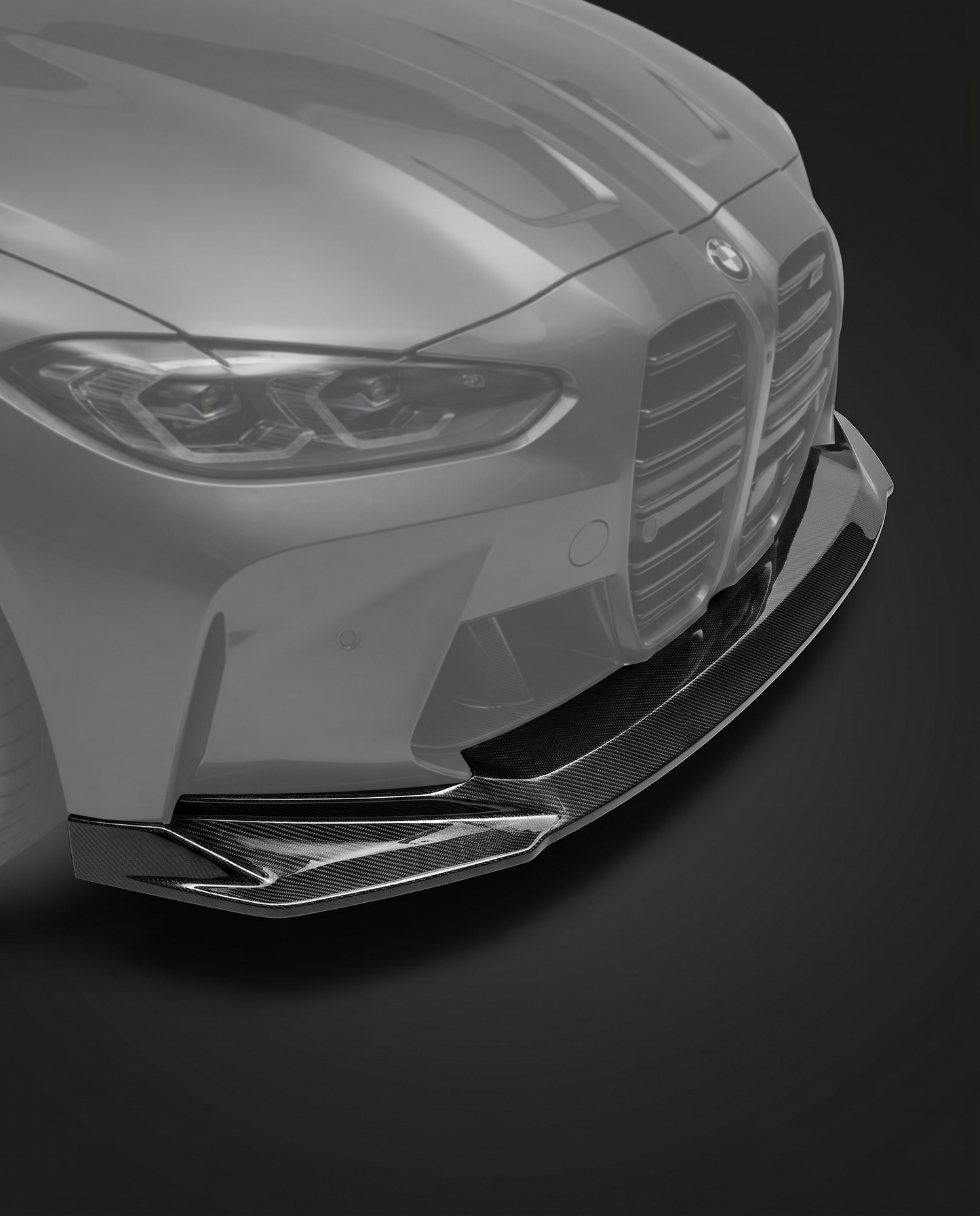 Gloss dry carbon fiber front lip splitter for BMW G80 M3 and G82 M4, vehicle ghosted, studio lighting reveals 2x2 twill weave depth