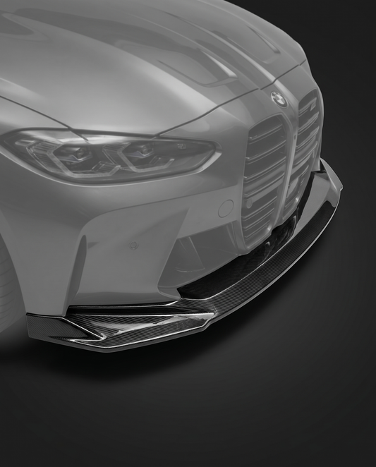 Gloss dry carbon fiber front lip splitter for BMW G80 M3 and G82 M4, vehicle ghosted, studio lighting reveals 2x2 twill weave depth