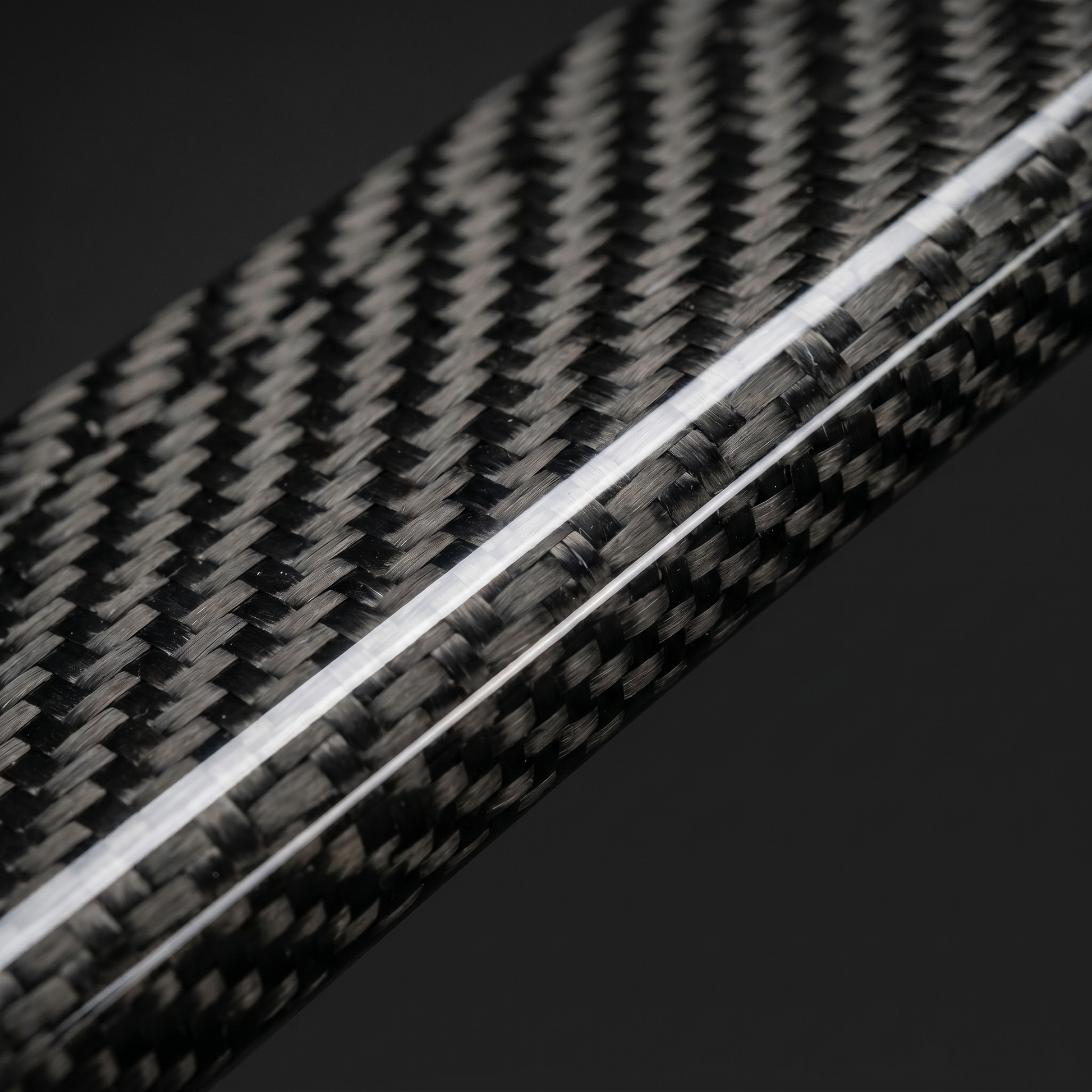 Macro of gloss 2x2 twill carbon weave on BMW M3 rear diffuser side extension, clean light-bar reflection and machined edge detail