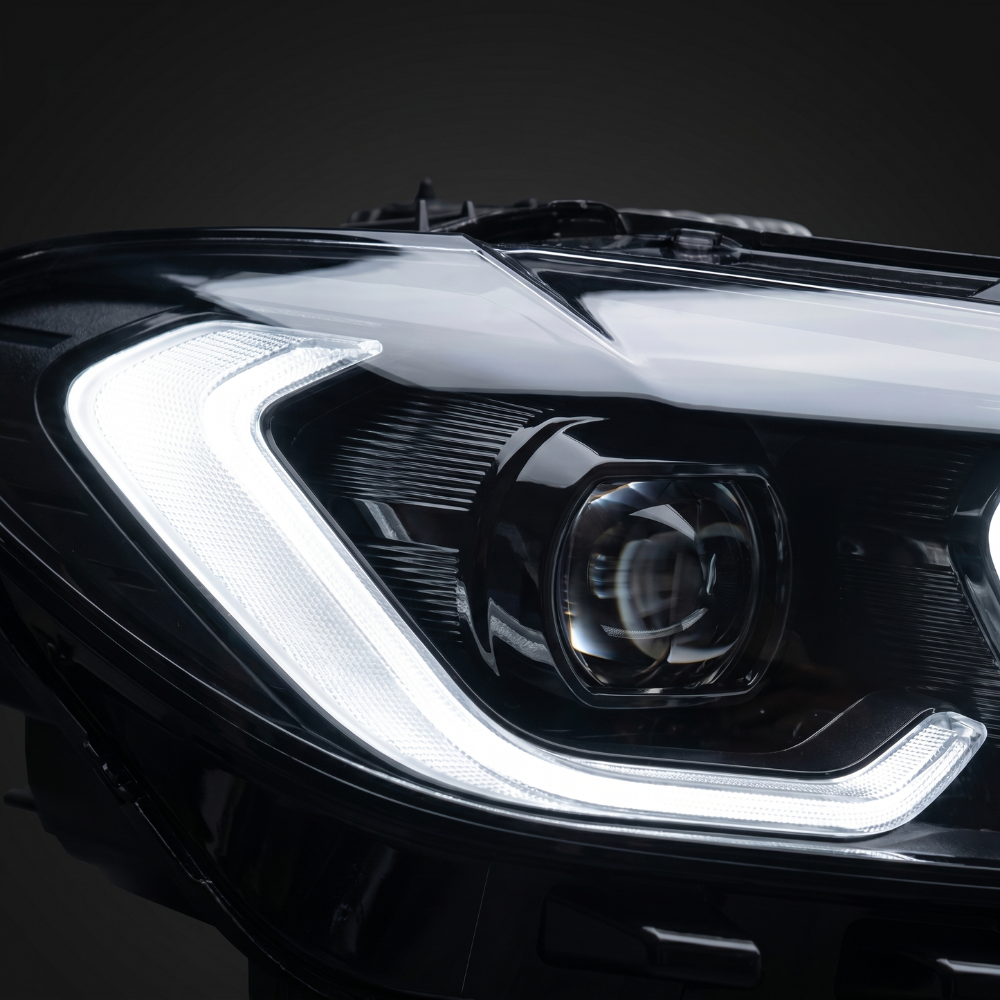 Macro of Snake Eye LED headlight projector and white DRL light-guide under clear lens, crisp optical detail and lens depth