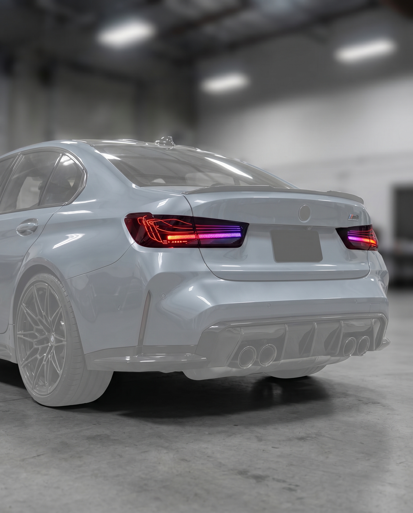 CSL RGB laser tail lights installed on ghosted BMW G80 M3 rear, refined RGB signature lit in blurred premium garage, plug-and-play