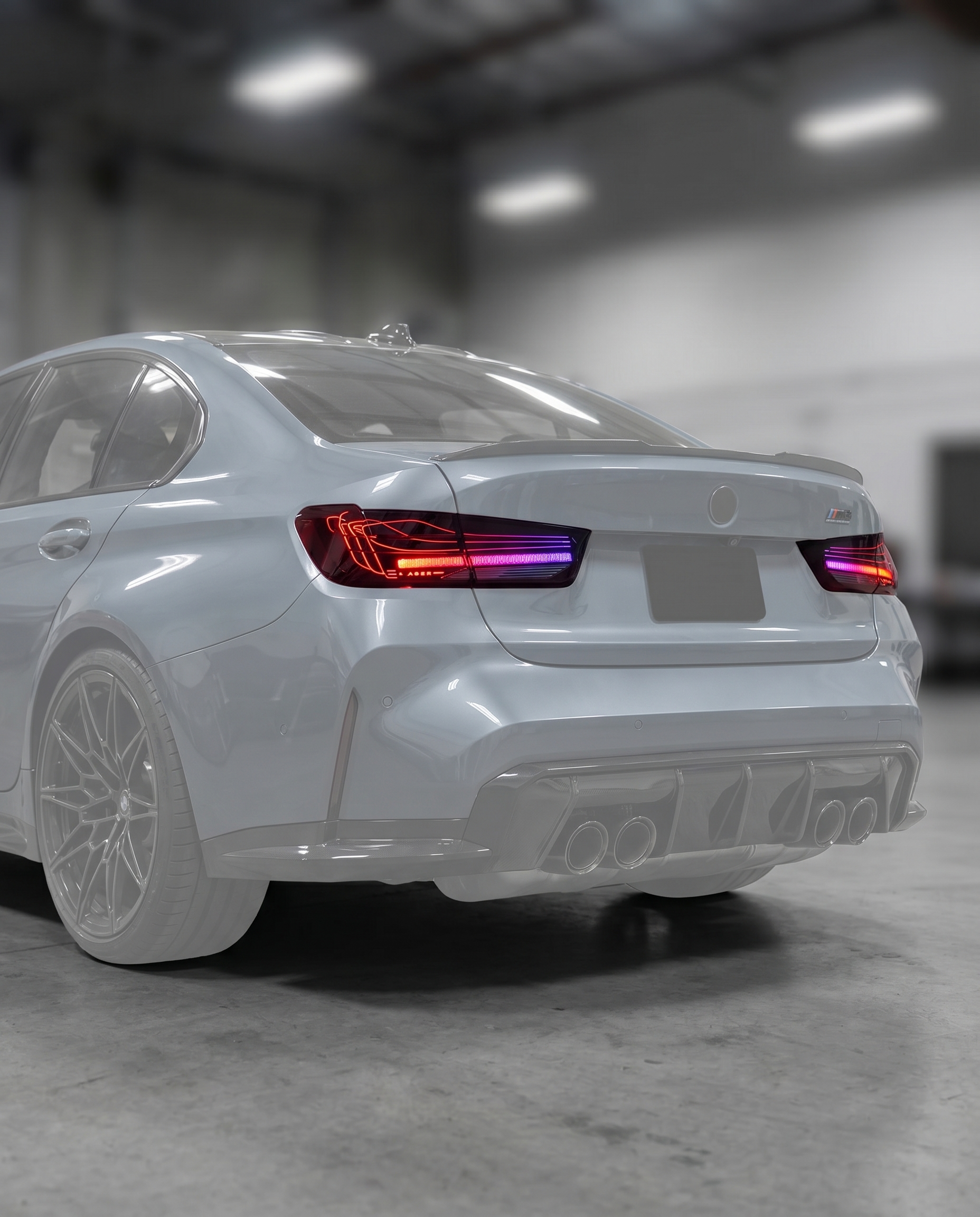 CSL RGB laser tail lights installed on ghosted BMW G80 M3 rear, refined RGB signature lit in blurred premium garage, plug-and-play