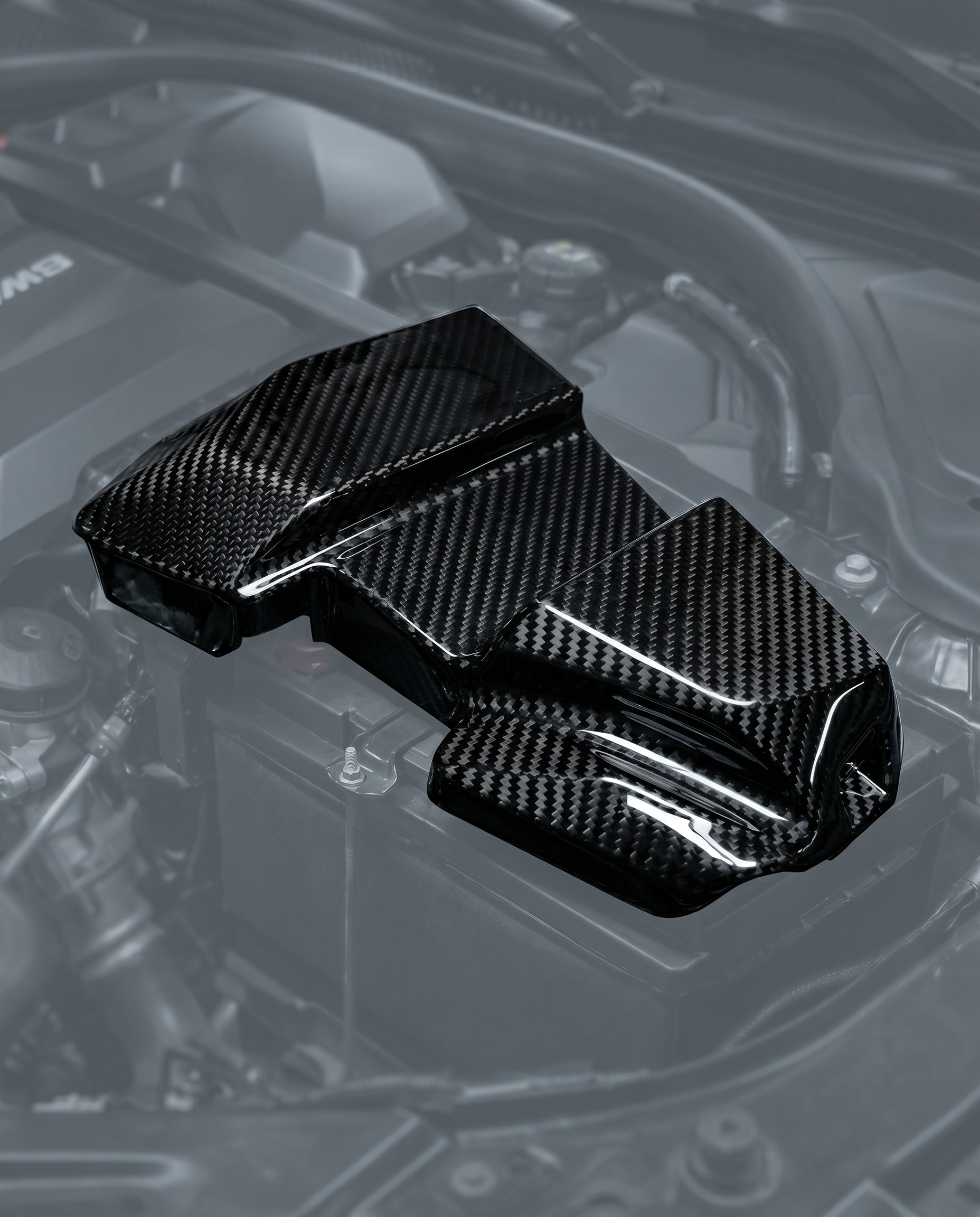 Gloss dry carbon fiber battery terminal cover for BMW G80 M3 G82 M4 G87 M2, engine bay ghosted, studio light reveals 2x2 twill weave