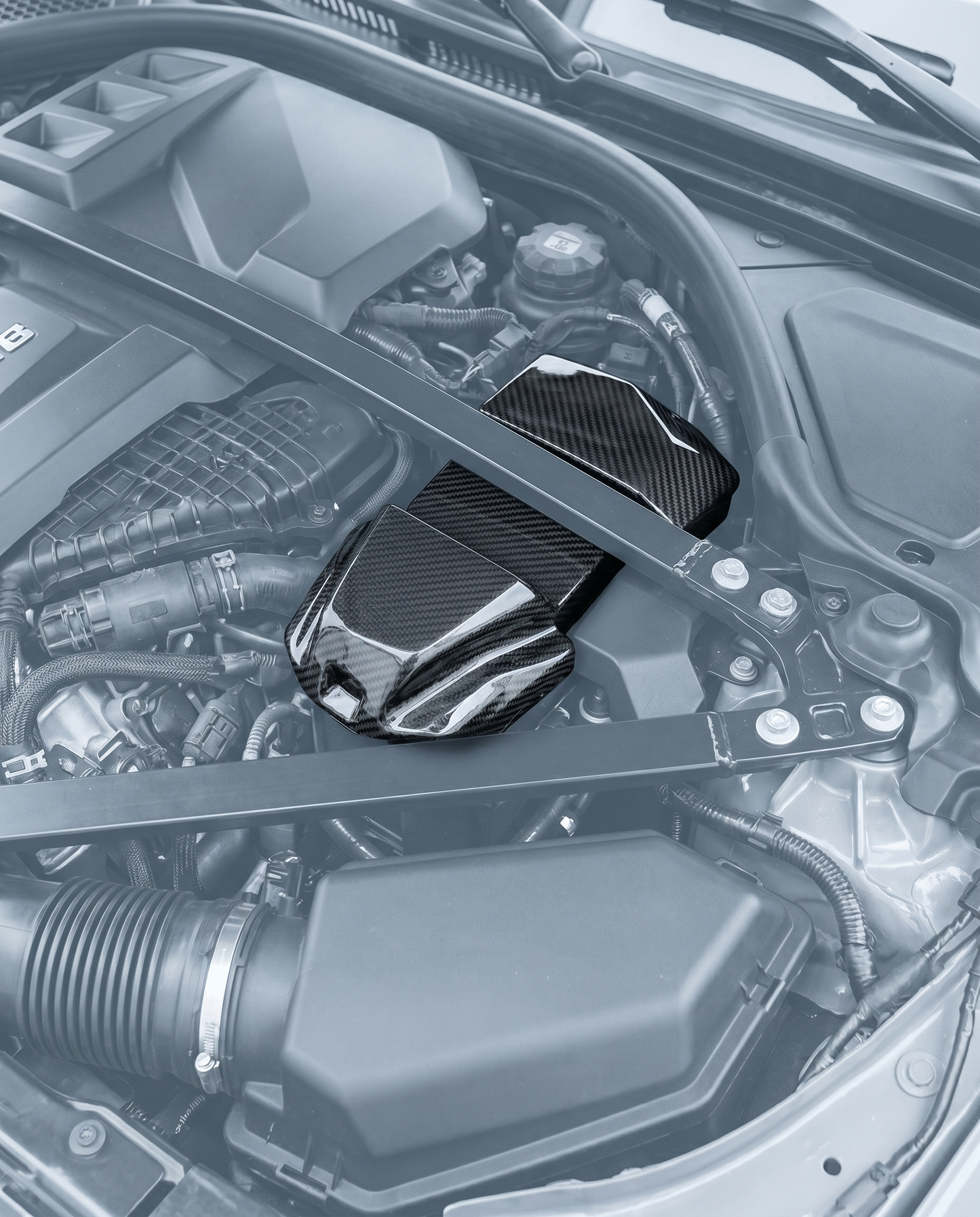 Dry carbon battery terminal cover installed in ghosted BMW G80 M3 S58 engine bay, clean factory-look finishing detail, OEM fit
