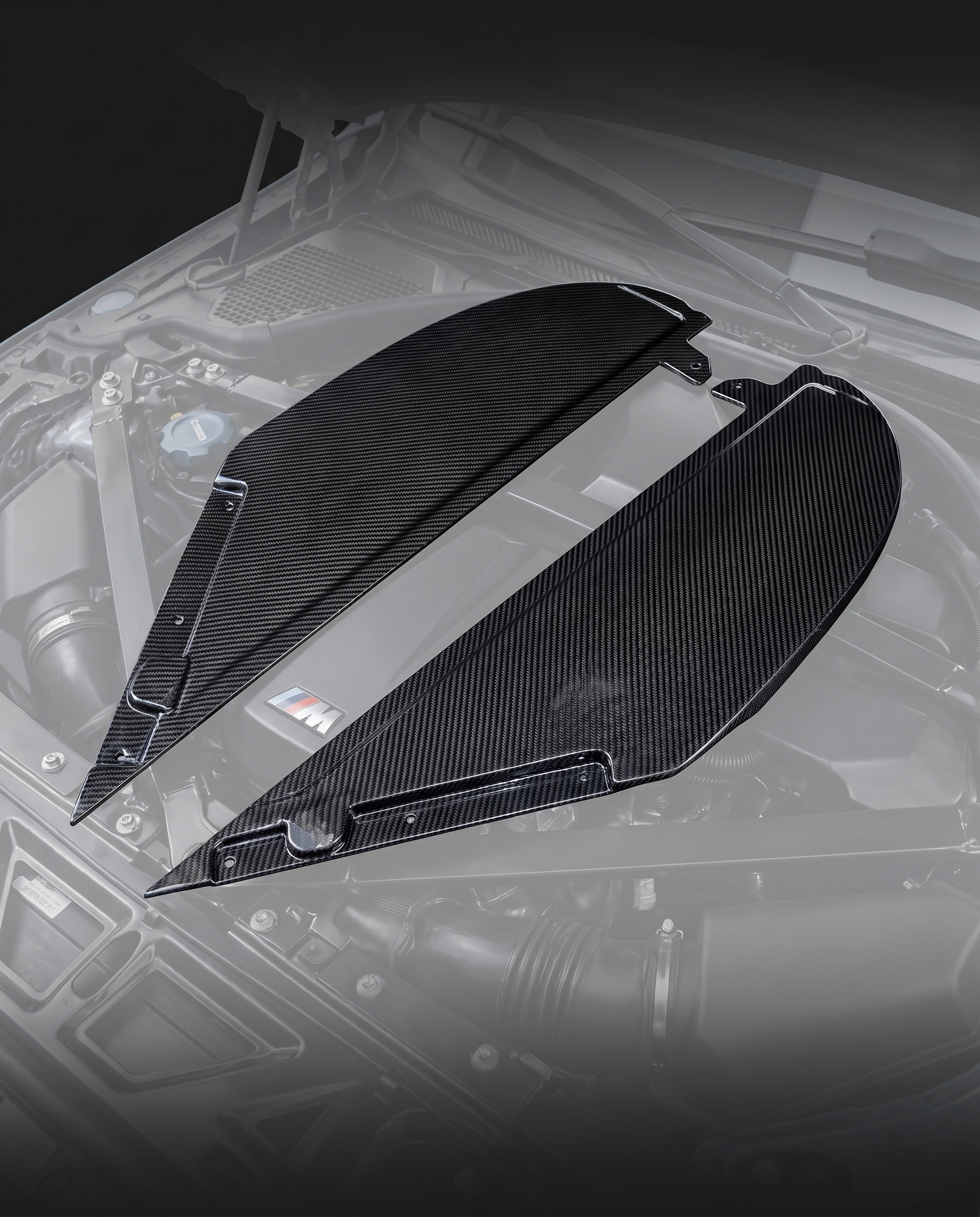 Gloss dry carbon fiber air intake cover for BMW G80 M3 and G82 M4, engine bay ghosted, studio light reveals 2x2 twill weave depth