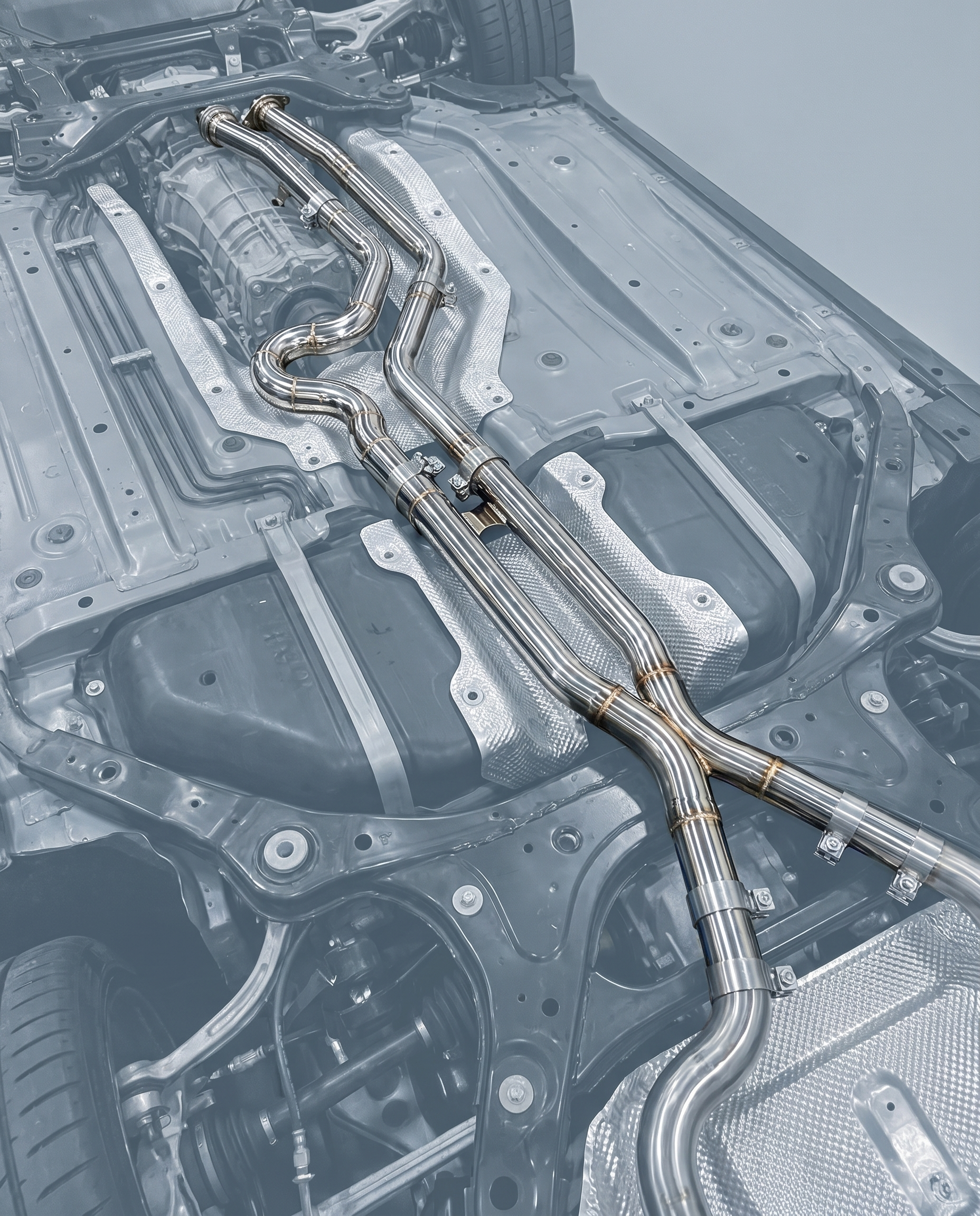 Equal-length stainless midpipe with brace routed under ghosted BMW G80 M3 underbody, polished tubing, OEM bolt-on fitment shown