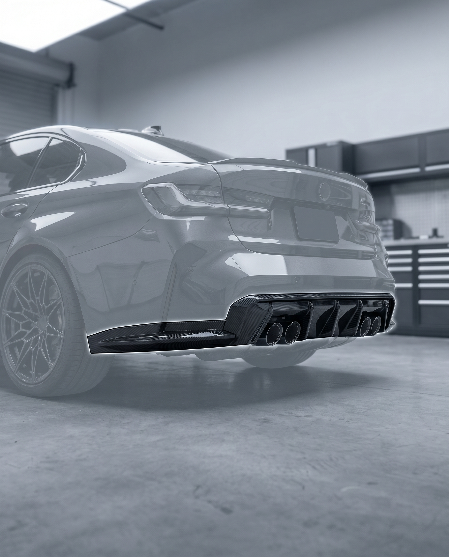 3D layered carbon diffuser installed under ghosted BMW G80 M3 rear bumper, aggressive motorsport rear aero, blurred premium garage