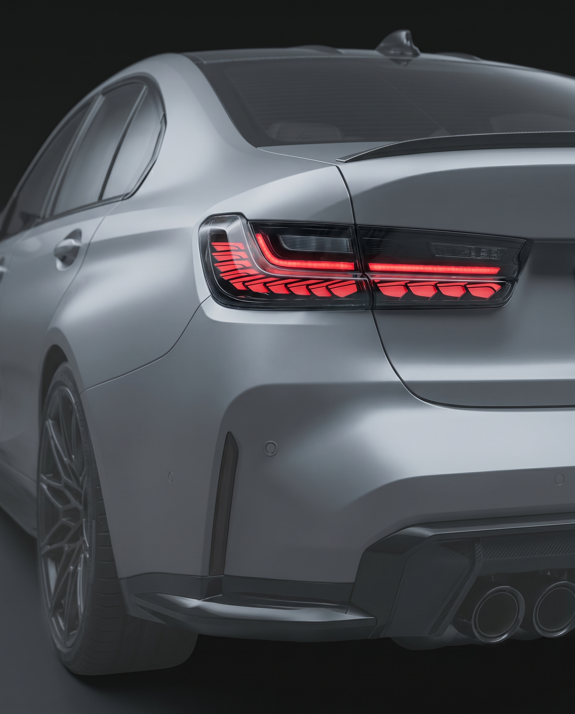 GTS-style clear-lens LED tail lights for BMW G80 M3 and G20 3-Series, clear lens with red LED bands lit, rear ghosted in dark studio