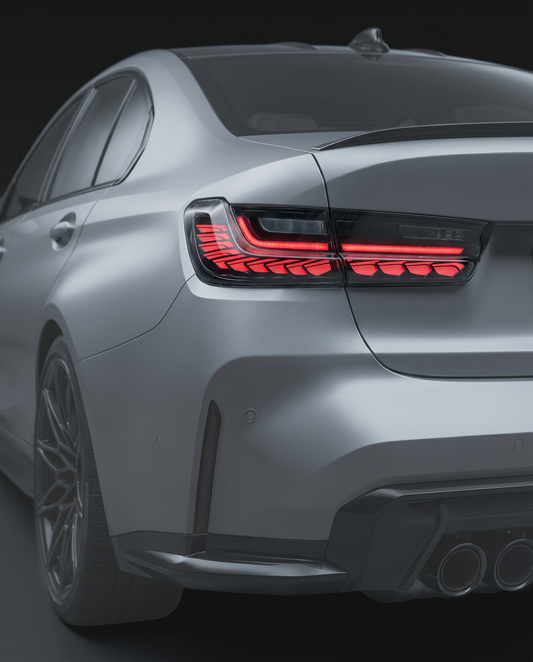 GTS-style clear-lens LED tail lights for BMW G80 M3 and G20 3-Series, clear lens with red LED bands lit, rear ghosted in dark studio
