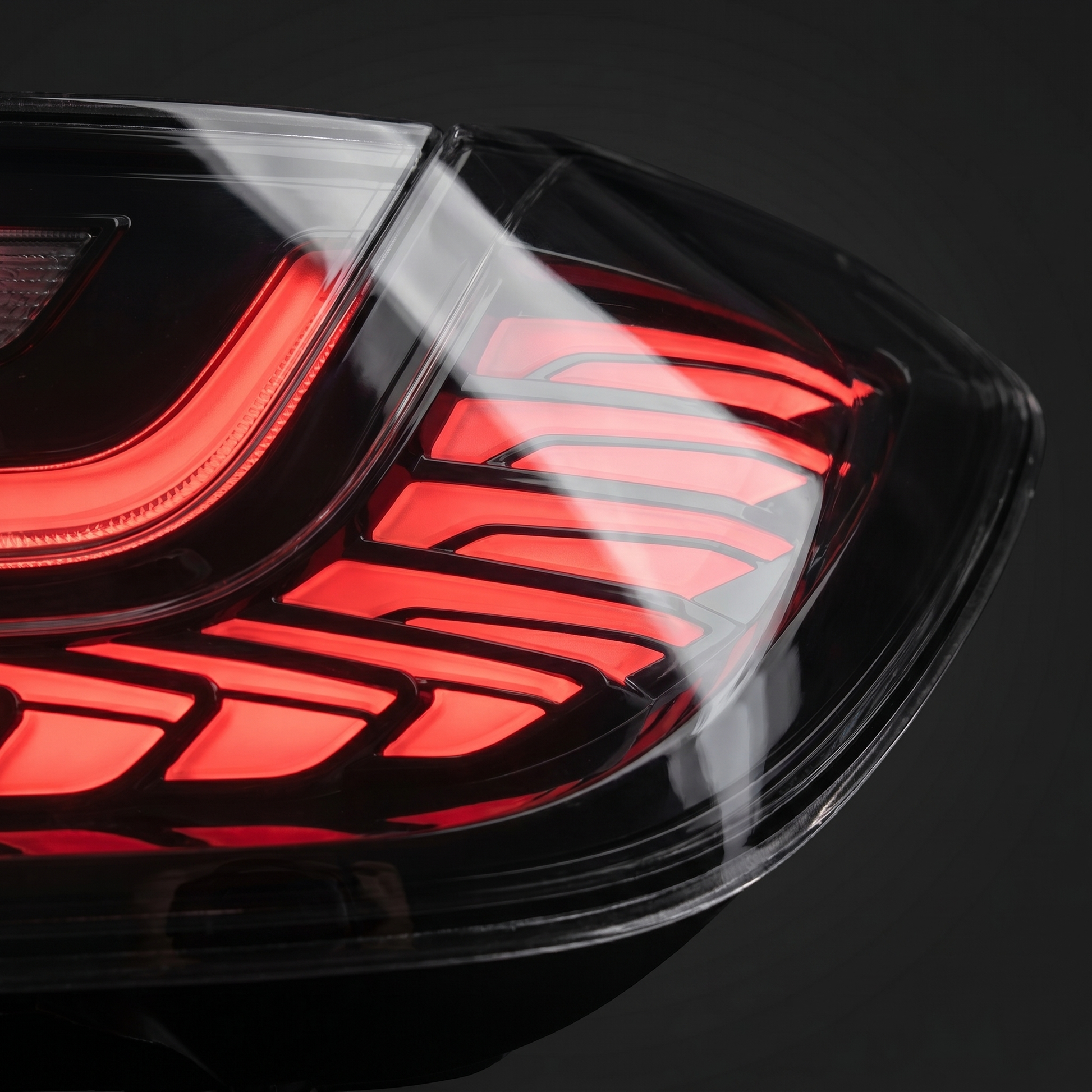 Macro of GTS clear-lens LED tail light optics, red LED bands and crystalline internal light-guide under crisp clear lens
