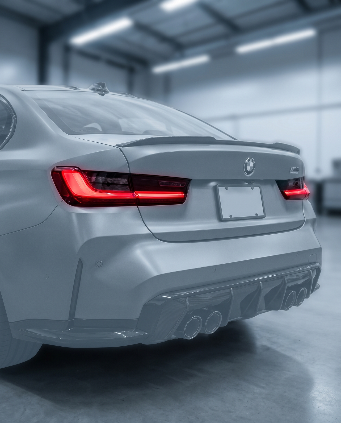 CSL laser LED tail lights installed on BMW G80 M3 rear, vivid red signature glowing in a premium dark garage setting