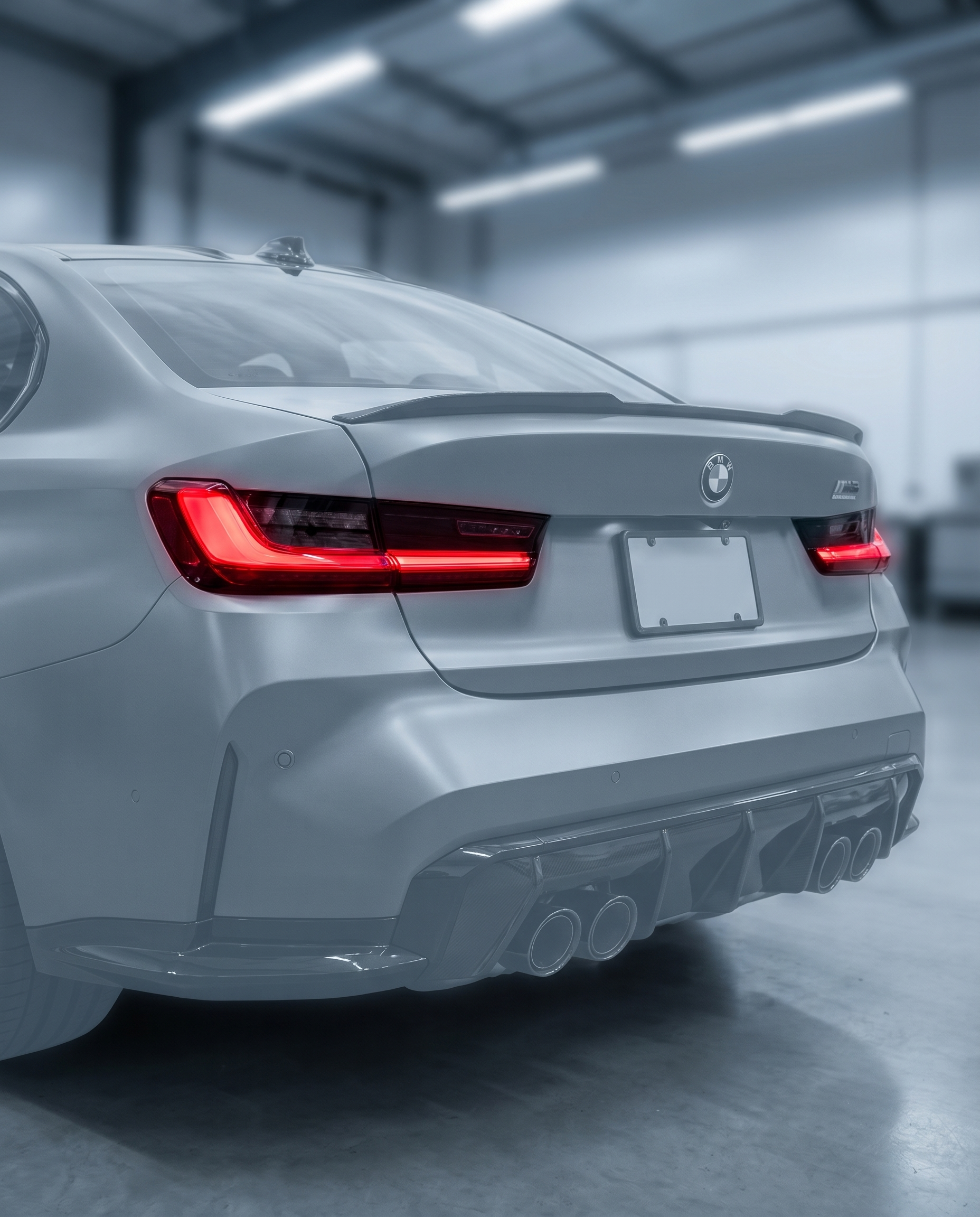 CSL laser LED tail lights installed on BMW G80 M3 rear, vivid red signature glowing in a premium dark garage setting