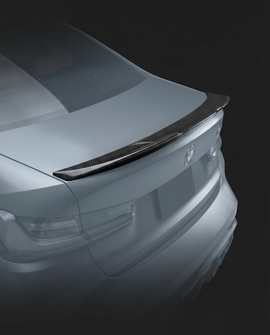 Gloss PSM-style dry carbon trunk spoiler for BMW G80 M3, studio hero shot showing high-kick profile and 2x2 twill weave