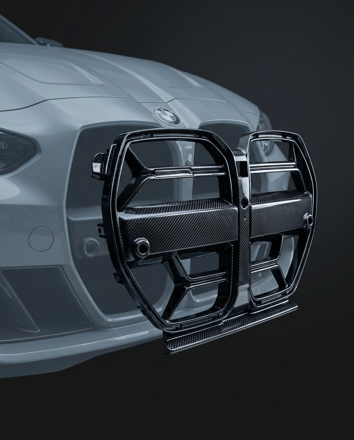 Gloss CSL-style carbon fiber front grille for BMW G80 M3, studio hero shot showing twin-slat mesh and 2x2 twill weave