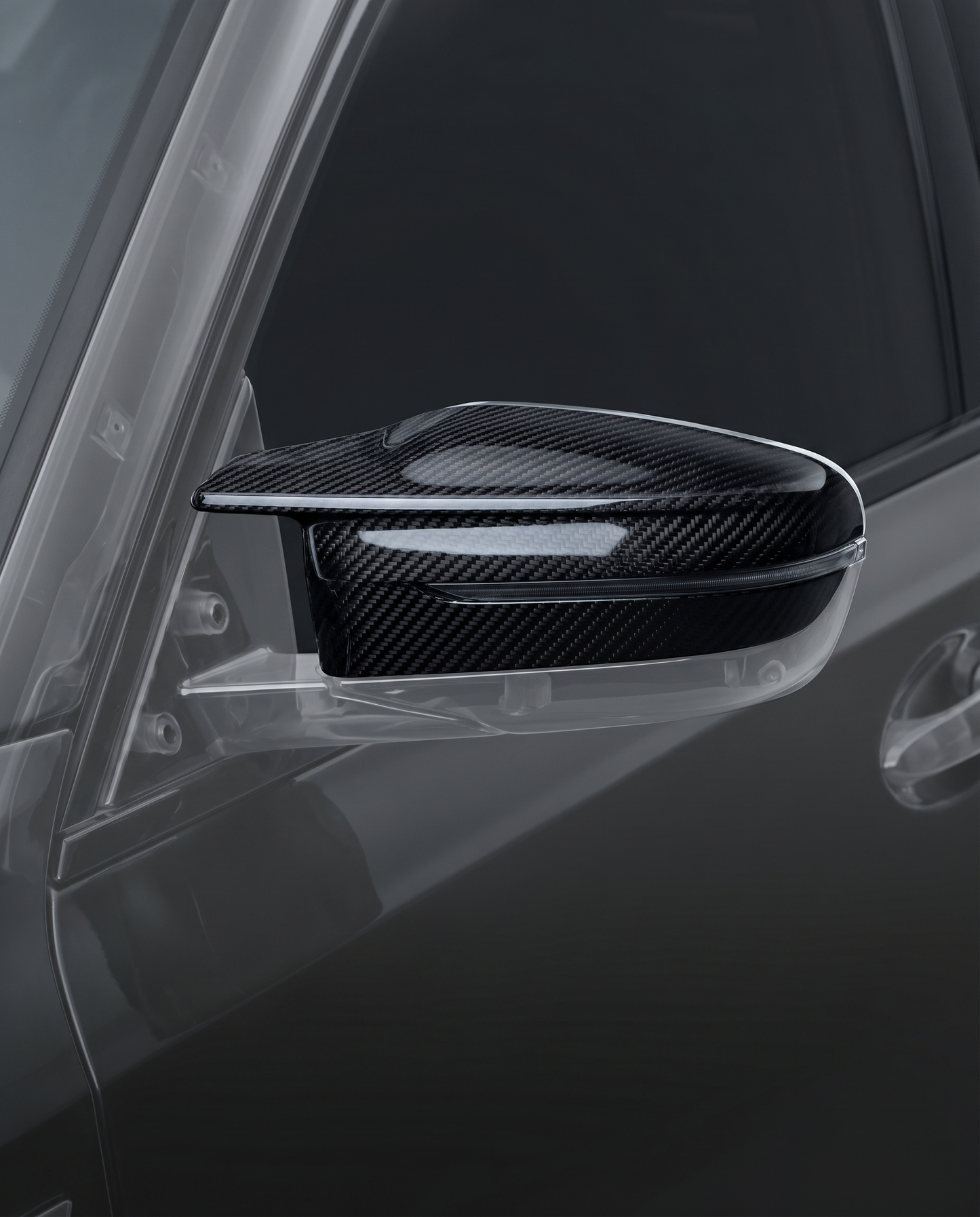 Gloss dry carbon mirror caps for BMW G80 M3, studio hero shot showing curved 2x2 twill weave and machined edge