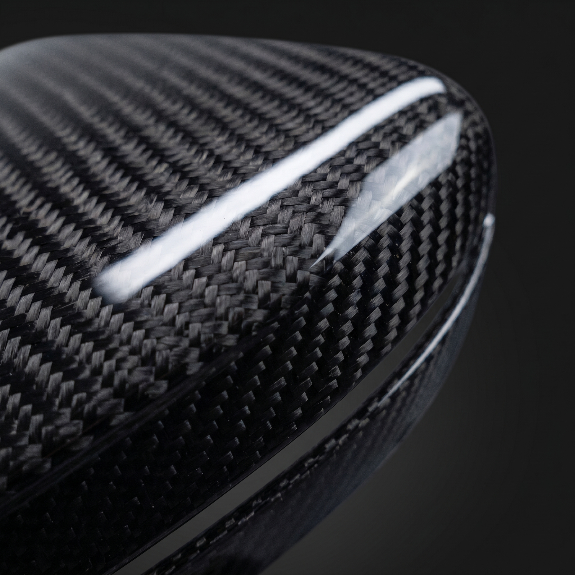 Macro of gloss 2x2 twill weave on dry carbon mirror cap for BMW G8X, clear-coat depth across the curved surface