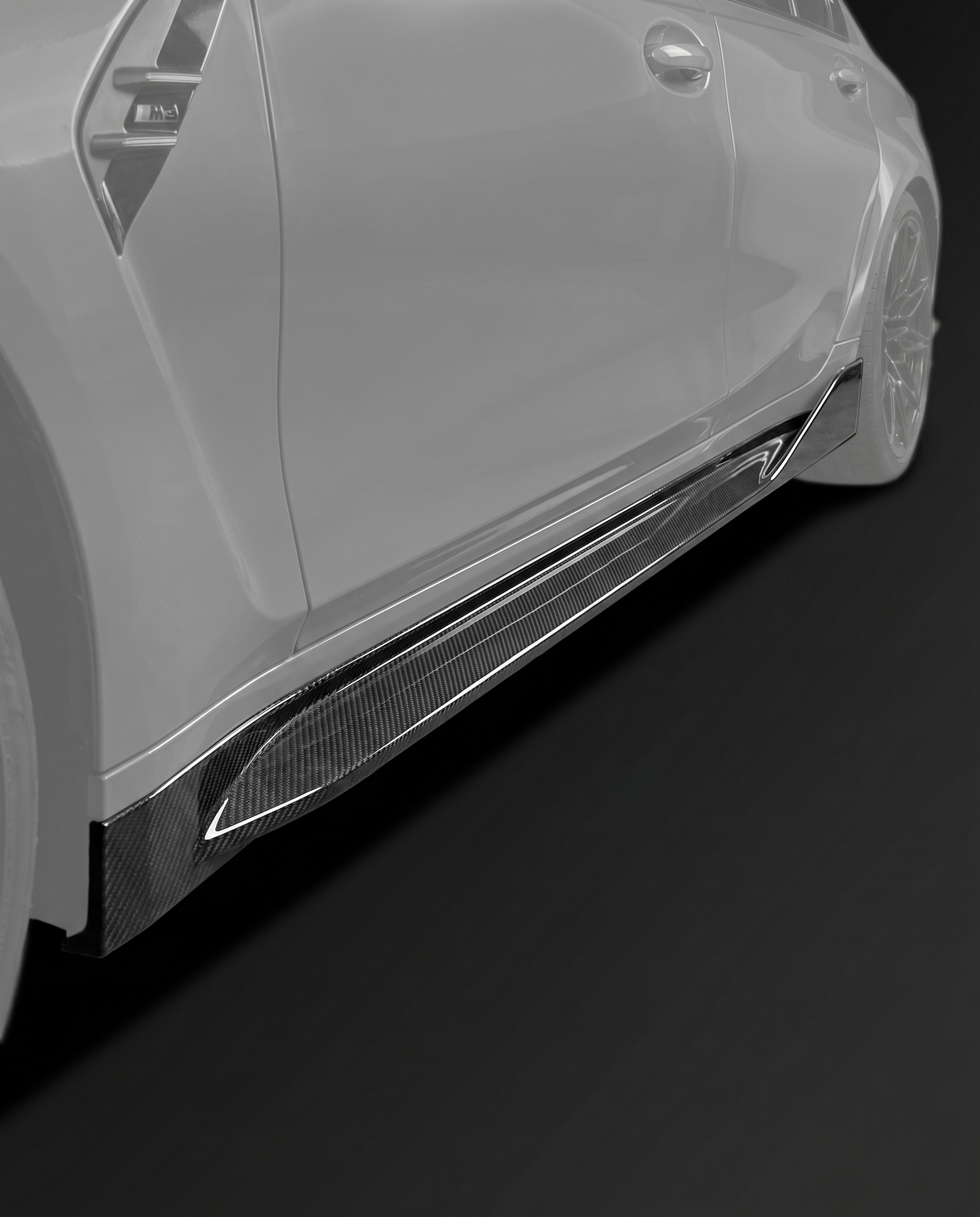 Gloss MP-style dry carbon side skirt extensions for BMW G80 M3, low studio hero shot showing slim profile and weave