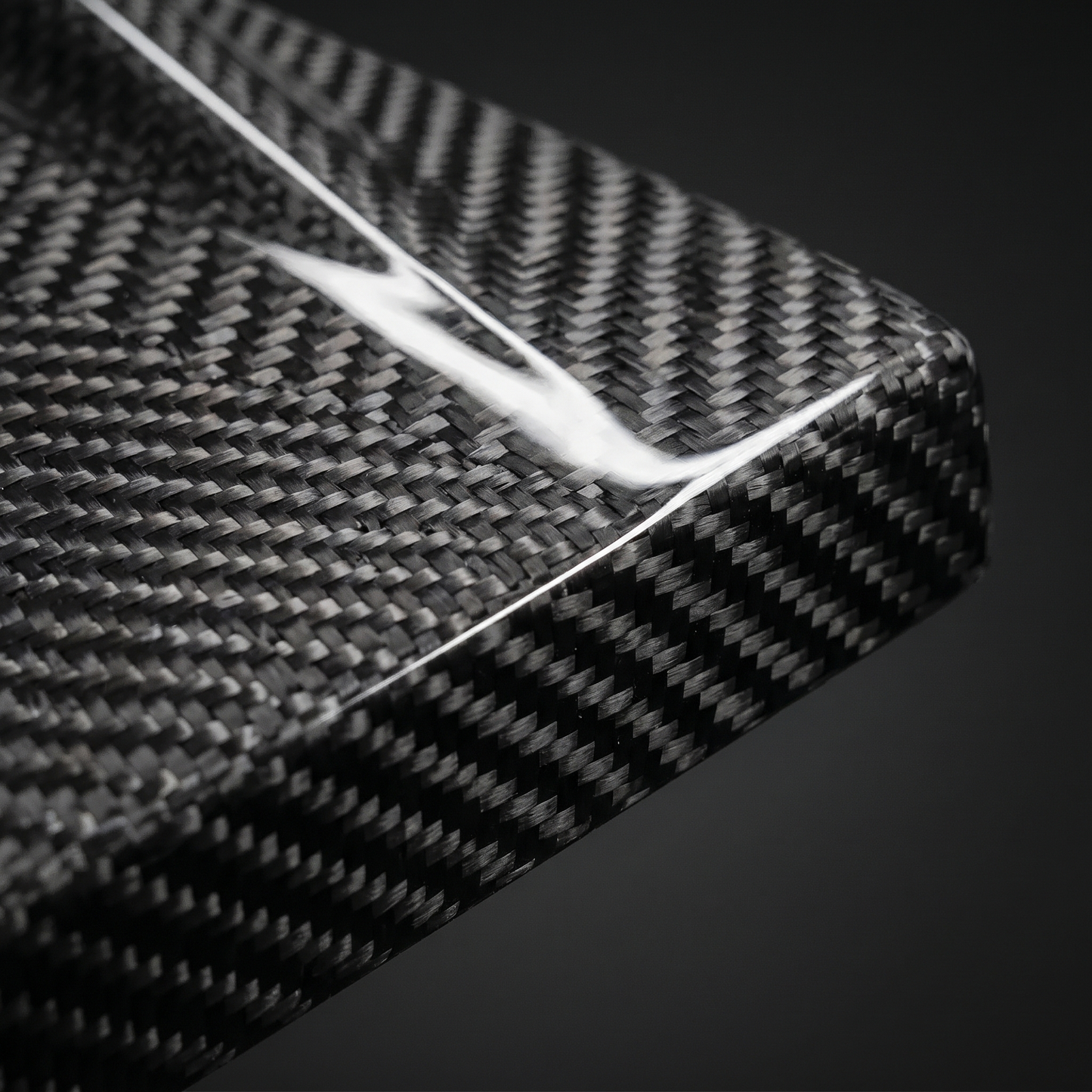 Macro of gloss 2x2 twill weave on MP-style carbon side skirt for BMW G80 M3, clear-coat depth and machined edge