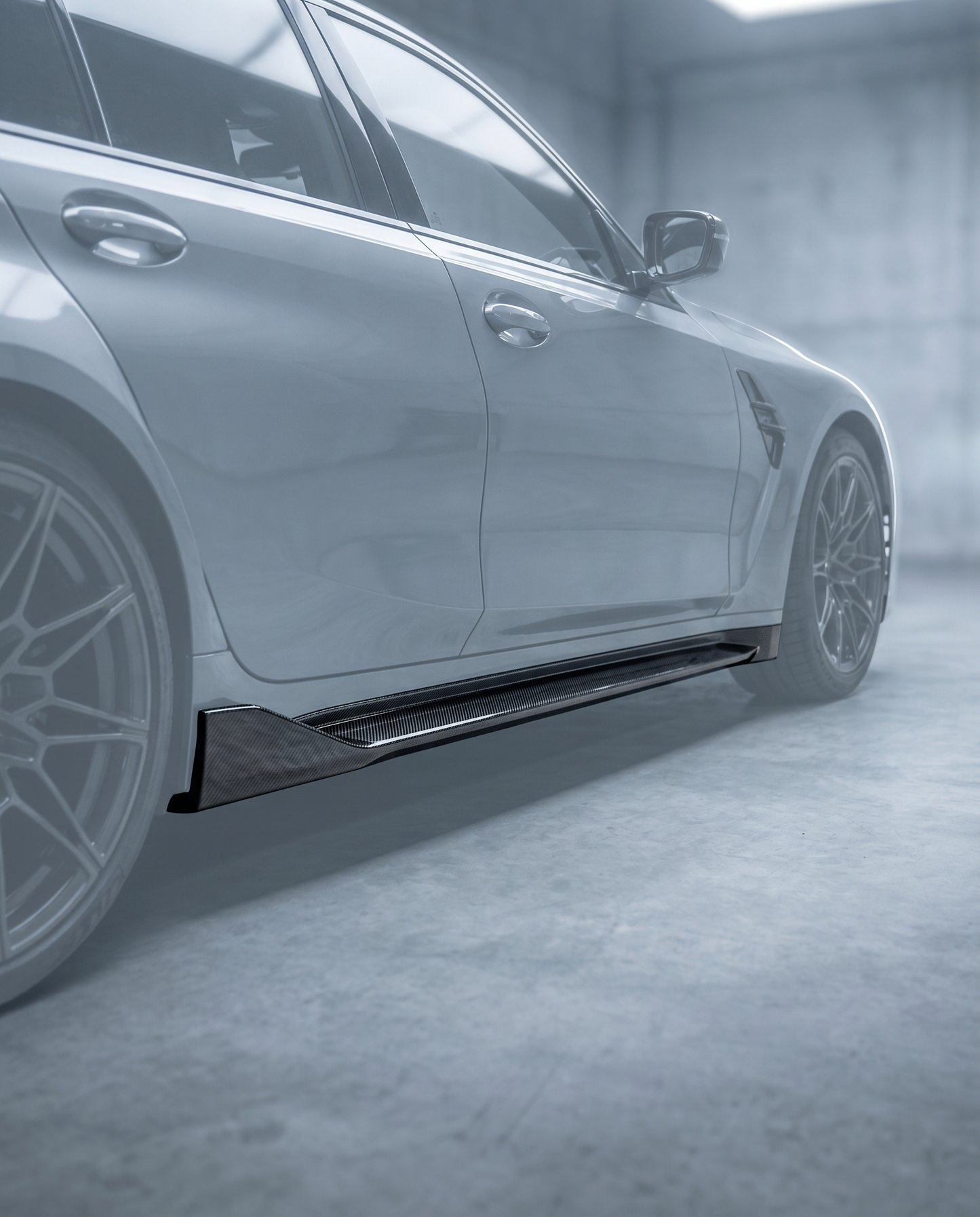 Gloss MP-style carbon side skirt installed along the rocker of BMW G80 M3, premium garage lighting shows lowered stance