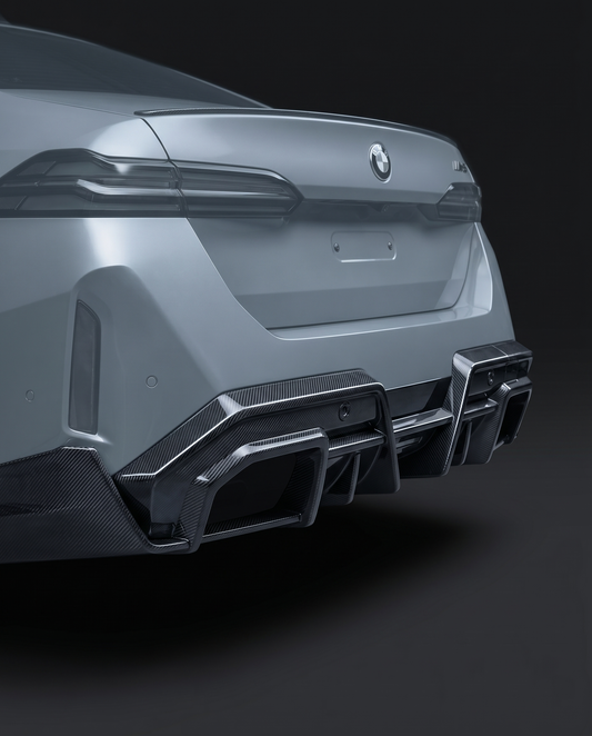Gloss SQ-style dry carbon rear diffuser for BMW G90 M5, low studio hero shot showing F1-inspired fins and weave