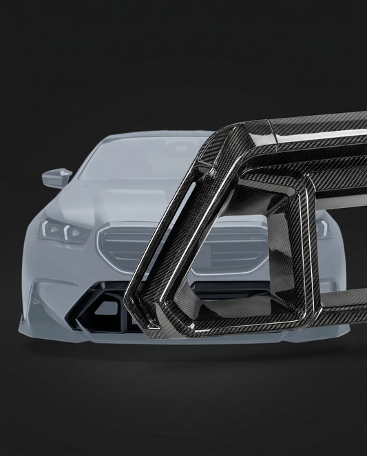 Gloss dry carbon front bumper center vent for BMW G90 M5, studio hero shot showing slats and carbon weave depth