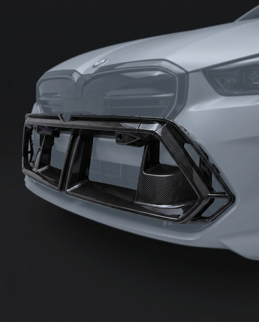 Gloss OE-style dry carbon front center vent for BMW G90 M5, studio hero shot showing subtle shape and carbon weave
