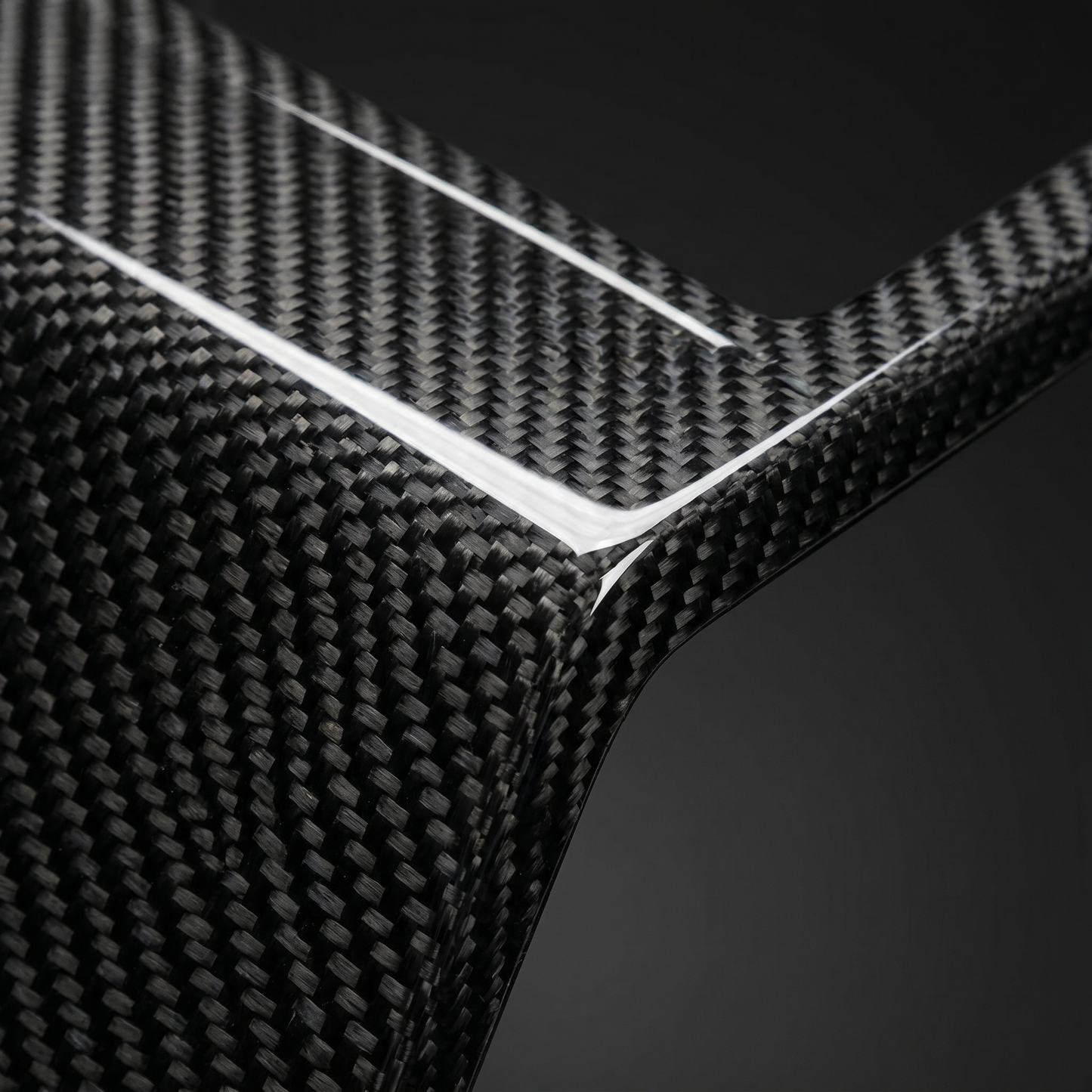 Macro of gloss dry carbon weave on OE-style G90 M5 front center vent, clear-coat depth and machined edge