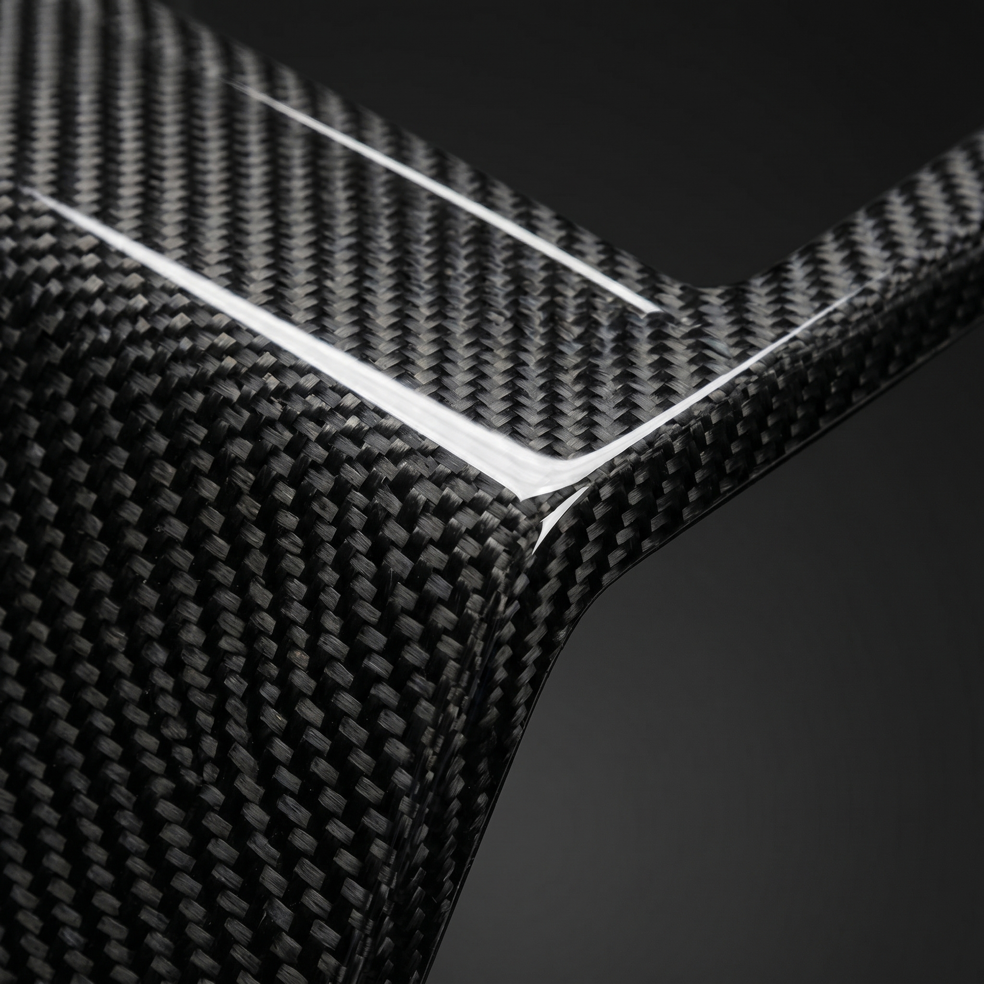 Macro of gloss dry carbon weave on OE-style G90 M5 front center vent, clear-coat depth and machined edge