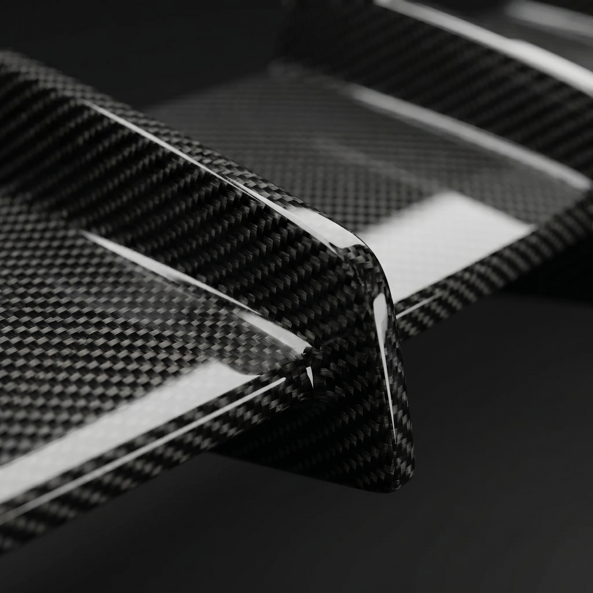 Macro of gloss 2x2 twill dry carbon weave on RZ-style rear diffuser fins for BMW G90 M5, clear-coat depth and crisp edges