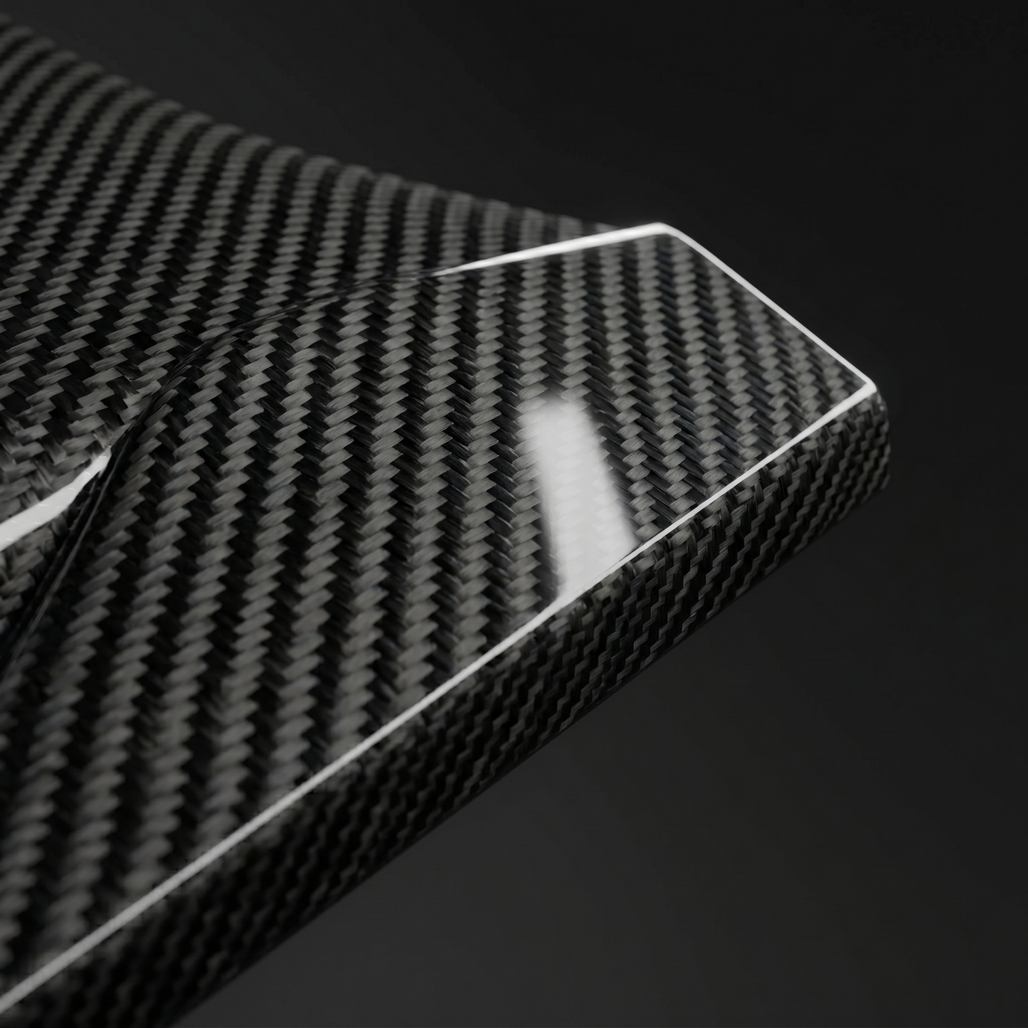 Macro of gloss 2x2 twill dry carbon weave on RZ-style side skirt edge for BMW G90 M5, clear-coat depth and machined edge