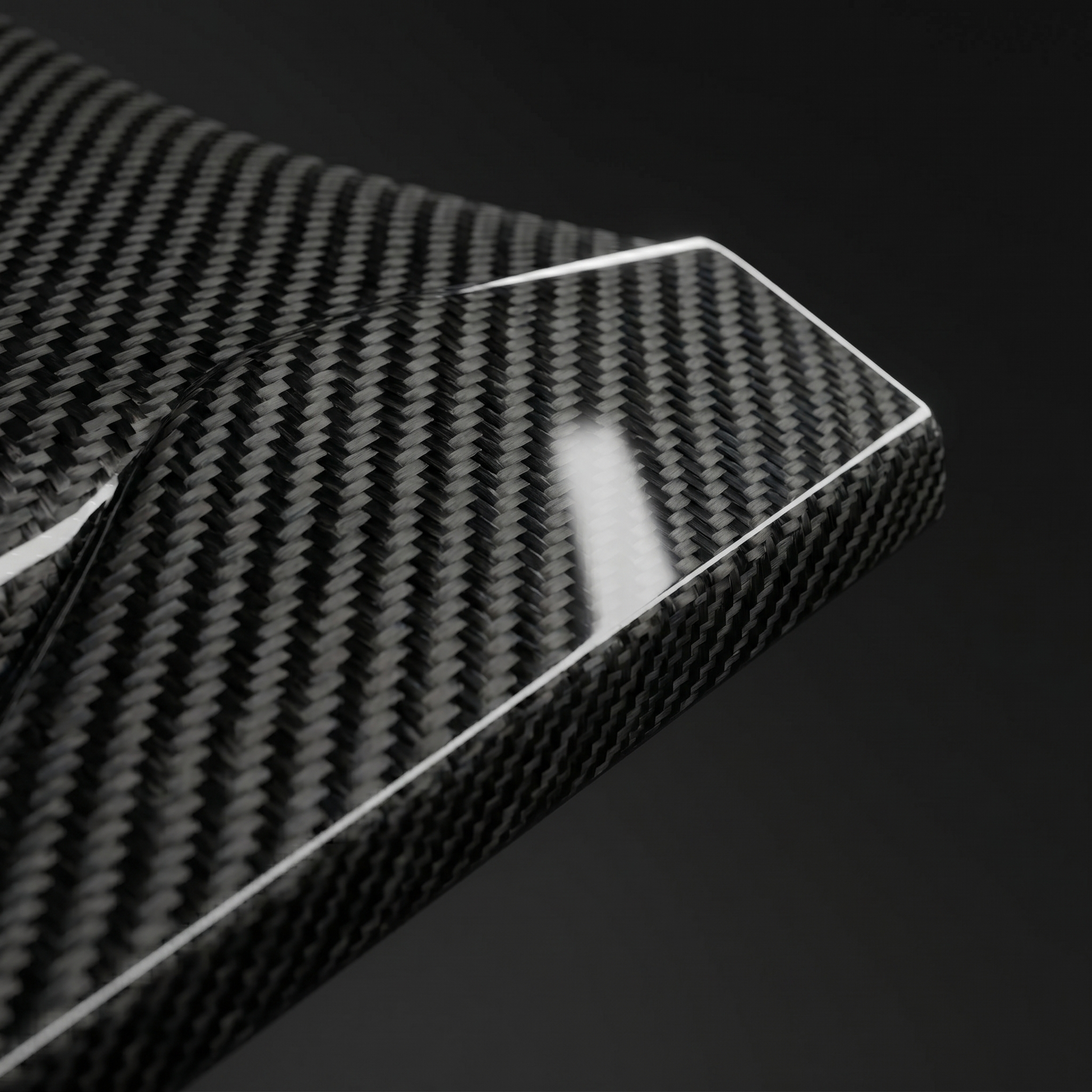 Macro of gloss 2x2 twill dry carbon weave on RZ-style side skirt edge for BMW G90 M5, clear-coat depth and machined edge