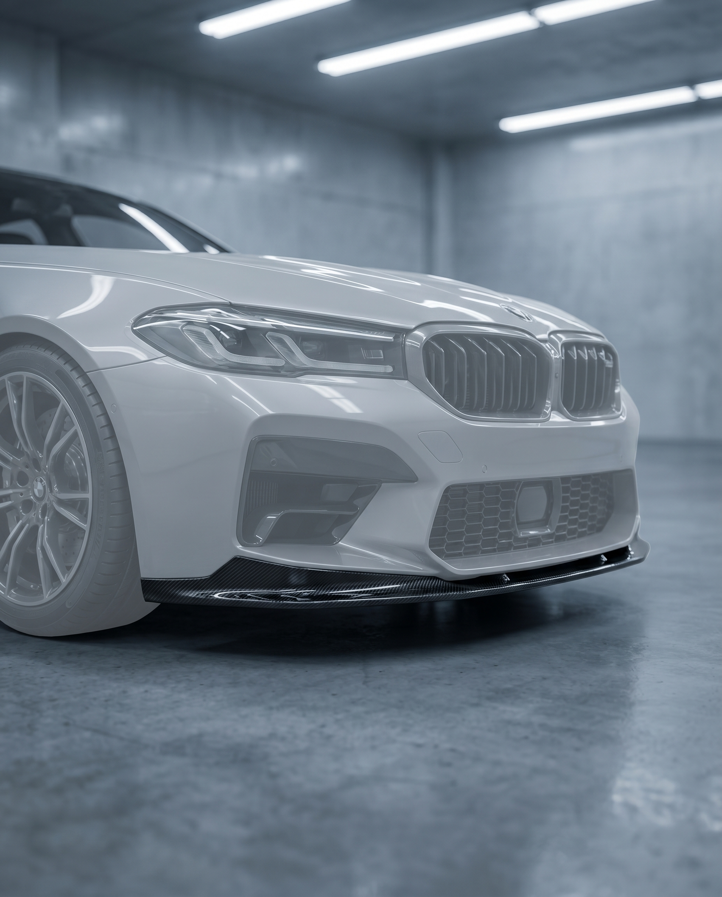 Type 1 gloss dry carbon front lip installed under the bumper of a ghosted 2025+ BMW G90 M5 in a blurred premium garage